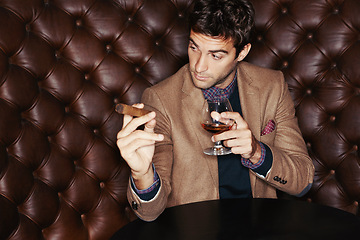 Image showing Cigar, businessman and drinking whiskey at club, fashion and person in a suit with alcohol at vintage bar. Mafia, smoking and serious person with scotch, beverage or brandy in glass for luxury at pub