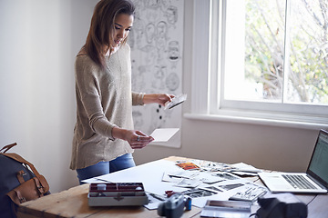 Image showing Woman, photographer and picture prints in creative studio for project planning for proposal, mood board or film roll. Female person, images and thinking for art portfolio for job, career or decision