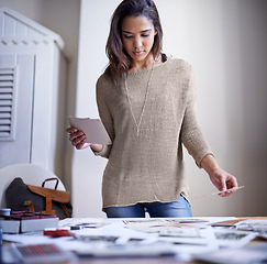 Image showing Woman, photographer and image prints in creative studio for thinking decision for project planning, career or proposal. Female person, pictures and desk or catalog portfolio for art, job or hobby