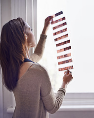 Image showing Woman, photographer and filmstrip negative to develop prints at window for retro images for portfolio, vintage or hobby. Female person, artistic and roll for picture in sunshine, photoshoot or career