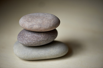 Image showing Stack, studio or stones at spa for healing, massage or wellness treatment therapy for balance. Pile, aromatherapy and rocks for a calm, zen or peace atmosphere at a natural salon on grey background
