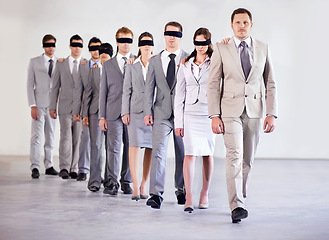 Image showing Business people, blindfold and leader for team confidence, united and lost in workplace. Management, employees and collaboration in uncertainty, control strategy and support in direction or workforce