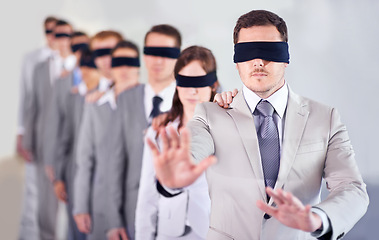 Image showing Business people, blindfold and leader in office, team and solidarity in workplace. Challenge, employees and collaboration in uncertainty, control strategy and support in searching or workforce