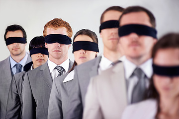 Image showing Business people, blindfold and employees lost at work, together and coworkers trust in workplace. Blind, team and collaboration in uncertainty, control strategy and support in challenge or workforce