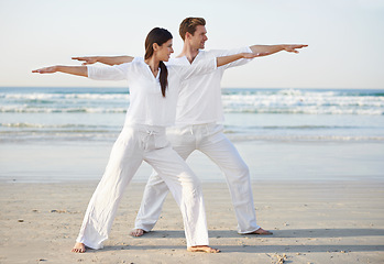 Image showing Couple, yoga and arms out, fitness on beach for zen and wellness, travel and mindfulness with holistic healing. People outdoor, exercise and balance, workout together for bonding with sea and nature