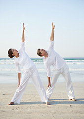 Image showing Stretching, yoga and couple on beach in morning for fitness, exercise and workout for performance. Nature, love and man and woman by ocean for pilates, wellness and healthy body outdoors together