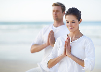 Image showing Couple, yoga and ocean with meditation, peace and sitting on sand in morning with mindfulness in summer. Man, woman and outdoor for namaste with spiritual growth, balance or zen at beach in Cape Town