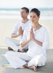 Image showing Couple, yoga and sea with meditation, zen and waves on sand in morning with mindfulness in summer. Man, woman and outdoor for namaste with spiritual growth, balance and peace at beach in Cape Town