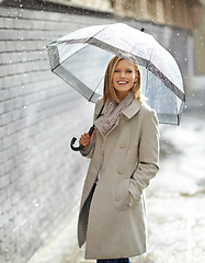 Image showing Woman, umbrella and portrait with rain in street, pride and smile with cover, weather and splash in city. Person, outdoor and road with travel, journey or commute in winter on sidewalk in Cape Town