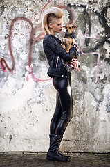 Image showing Woman, love and dog in edgy fashion with punk rock hairstyle, funky and bonding with chihuahua by graffiti wall. London, designer or leather jacket in urban town or care for pet animal by street art