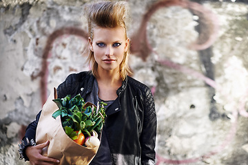 Image showing Woman, portrait and fashion with vegetable grocery in city, cool and punk rock hairstyle in leather jacket by graffiti wall. California person, face and funky in town with food shopping by street art