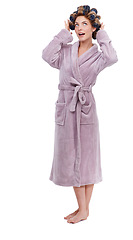 Image showing Hair, morning and bathrobe with woman curling in studio isolated on white background for pampering. Wellness, beauty and cosmetics with young person in bathroom to relax for haircare treatment