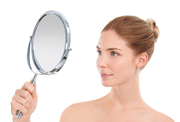 Image showing Woman, mirror and skincare with check in studio for glow, cosmetics or healthy by white background. Girl, person or model with facial skin, beauty or results with reflection, dermatology or aesthetic