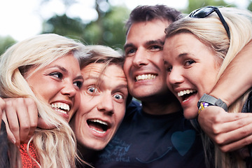 Image showing Face, smile and hug with excited friends closeup outdoor in nature together for travel, festival or adventure. Party, energy or wow with man and woman group laughing in forest or woods in summer