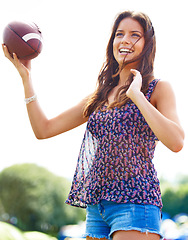 Image showing Smile, sports and woman throwing football outdoor on field for fitness, recreation or fun in summer. Sky, camping and adventure with happy young person playing catch in nature, forest or woods