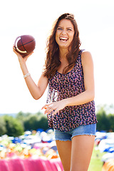 Image showing Portrait, sports and laughing with football woman outdoor on campsite for festival, fun or recreation. Fitness, exercise or game with happy young camping person throwing ball on grass to play catch