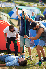 Image showing Beer, festival or drunk friends drinking together on vacation or outdoor social event in summer. Music concert, crazy party games celebration or excited people with hose funnel or alcohol pipe tube