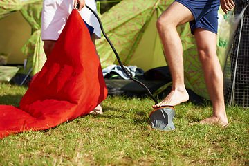 Image showing Camp, nature and people with pump for mattress on outdoor vacation, travel or holiday in field. Grass, legs and friends preparing inflatable bed on campsite with tent on lawn for weekend trip.