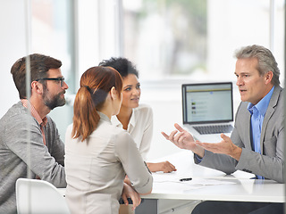 Image showing Senior businessman, meeting and discussion with team in finance or coaching with documents at office. Man, CEO or executive talking to group of employees for financial growth or revenue at workplace