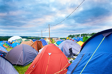 Image showing Camping, tents and outdoor music festival in park on holiday or vacation in summer. Camp, site and shelter setup at party, event or travel in countryside for concert, adventure and crowded carnival