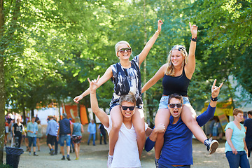 Image showing People, happy and crazy celebration in forest for cheerful, bonding or fun outdoors together in nature. Group of friends, smile and excited in summer for festival, camping or social event in park