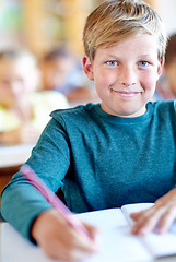 Image showing Student, portrait and writing notes for learning in classroom, boy and problem solving at school. Male person, child and study information for exam prep in notebook, solution and journal for test