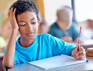 Image showing Student, boy and writing notes for studying in classroom, book and problem solving at school. Male person, child and information for exam prep in notebook, solution and journal for assessment or test