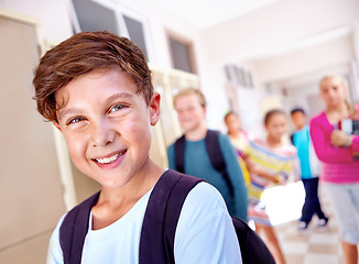 Image showing Student, portrait and boy with smile in hallway with education, study and backpack for back to school. Youth, young kid and learning with friends on campus with children and happy from class and fun