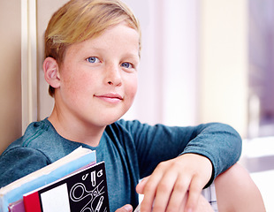 Image showing Student, portrait and boy with book in hallway with education, study and textbook for back to school. Youth, young kid and learning on ground on campus with child and happy from class and break