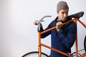 Image showing Man, studio and bicycle for sustainability, transportation or exercise on white background. Hipster cyclist, carbon neutral and eco friendly travel for environmental commute or fitness and trip