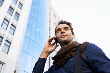 Image showing Man, city and buildings with smartphone for phone call, conversation or networking in Chicago. Male person, technology and smile with communication, contact and happy in morning from low angle