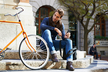 Image showing Man in city, bicycle and cellphone with travel, carbon footprint and communication with tech and cycling. Eco friendly transportation, using phone for location and connectivity for journey with bike