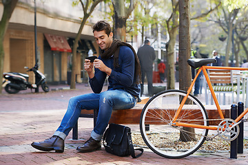 Image showing Phone, bike and business man in city, sitting on bench for break with social media browsing or app. Smile, contact and bicycle with confident young employee typing text message outdoor in urban town