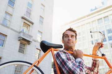 Image showing Man, lifting bicycle and smile for travel, commute or journey to apartment in Chicago from behind. Male person, happy and road bike for sustainability, environmentally friendly and mobility in city