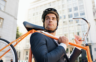 Image showing Businessman, holding bicycle and helmet in city for travel, commute or journey to work in Chicago. Male person, buildings and road bike for sustainability, eco friendly and mobility in morning