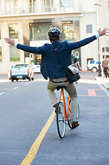 Image showing Back, travel and bicycle with man, freedom and celebration with commute and adventure in a street. Person, outdoor and cyclist with a bike and eco friendly transportation with buildings or urban town
