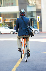 Image showing Businessman, back and city with bicycle for eco friendly and sustainability travel for morning commute to work. Road, bike and entrepreneur on street with cycling to job in town for carbon footprint