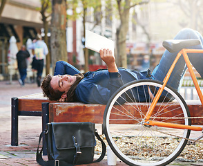 Image showing Relax, city and happy with man, tablet and bicycle with connection and online reading with internet and social media. Person, outdoor and New York with guy and technology with ebook and website info