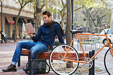 Image showing Happy, city and smile with man, tablet and bicycle with adventure and digital app with email and social media. Person on bench, outdoor and New York with guy and technology with connection and typing