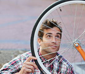 Image showing City, inspection and man with bicycle wheel, maintenance and road with guy and transportation with sustainability. Check bike, person or hipster with cyclist and eco friendly with cycling or street