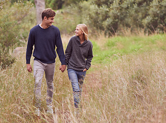 Image showing Happy couple, walk and holding hands in the countryside, forest or summer outdoor for hiking on valentines day date. Smile, man and woman in nature for support, love or romantic connection together