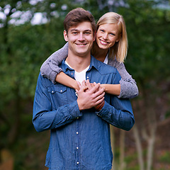 Image showing Couple, portrait and happy with hug in nature or countryside for holiday, vacation or anniversary getaway. Love, man and woman with face, smile and embrace in woods or forest for relationship or care