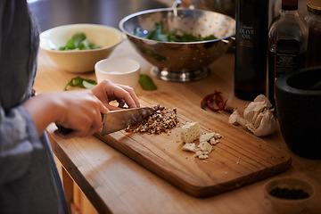 Image showing Cooking, hands and salad chop in a home with diet, nutrition and healthy food with person. Kitchen, knife and leaves for organic and vegan lunch with bowl and wood board in a house with wellness