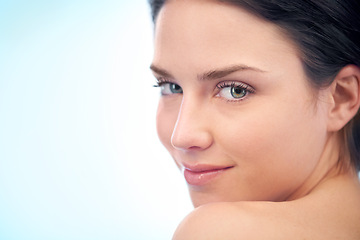 Image showing Wellness, skincare and portrait of woman in studio with health, cosmetic and facial routine. Beauty, glow and young female person with face dermatology treatment by blue background with mockup space.