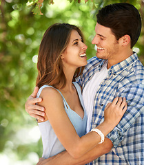 Image showing Man, woman and happy with hug in forest for bonding, connection and love in Canada. Couple, smile and summer on date with romantic embrace for admiration, care and affection with bokeh background