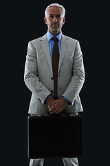 Image showing Senior, businessman and portrait or briefcase in studio with confidence and pride for corporate career or job. Mature, entrepreneur and ceo with face, thoughtful and contemplating on black background