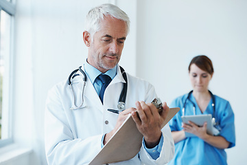 Image showing Checklist, research or mature doctor writing medical notes, feedback review or schedule in hospital. Clipboard, healthcare paperwork update or man in clinic working on a science report or medicine