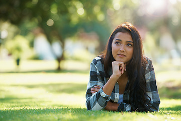 Image showing Ideas, nature or woman thinking on grass to relax for rest in garden, park or field with peace. Daydream, vision or female person on break with smile for summer vacation, holiday or wellness on lawn