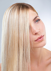 Image showing Straight hair, beauty and serious woman in makeup, care or thinking isolated on a white studio background. Face, hairstyle and blonde model in cosmetics, hairdresser and salon treatment for keratin