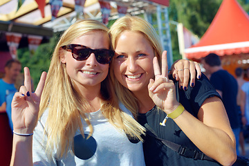 Image showing Women, peace sign and portrait at music festival in nature, excited and social with bonding together. Friends, face or celebration in summer on holiday adventure, relax or unity at concert in woods